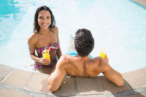 This is a picture of a happy couple in their clean swimming pool in Amarillo, Texas.